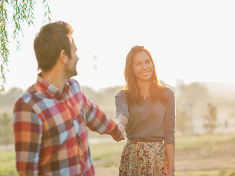 Couple Holding Hands Walking Away, smiling