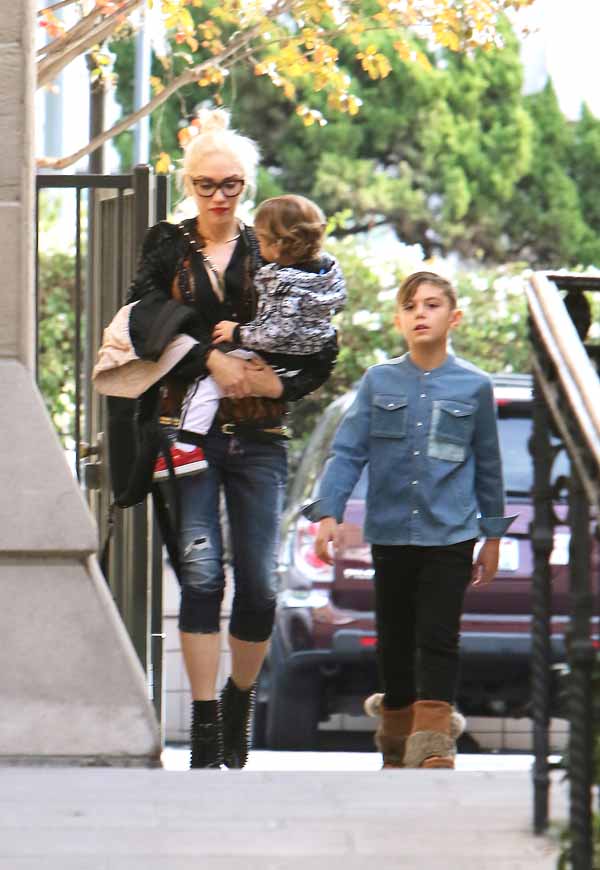Gwen Stefani looks exhausted, wearing black glasses as she arrives at church with sons Apollo and Kingston amid her growing romance with country music star and fellow The Voice coach Blake Shelton. Gwen wears high-heeled studded black and red booties, and skin tight capri blue jeans, and Kingston looks grown-up in a denim button shirt, black jeans and comfy brown boots. Sunday, December 6, 2015. X17online.com