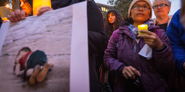MELBOURNE, AUSTRALIA - SEPTEMBER 07:  People hold candles during the quiet vigil in rememberence of Aylan Kurdi on September 7, 2015 in Melbourne, Australia. Thousands of people around Australia gathered to remember Aylan Kurdi, the young Syrian refugee who died last week and to protest the Australian Government's current refugee policy.  (Photo by Chris Hopkins/Getty Images)