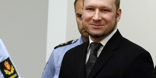 Norwegian mass killer Anders Behring Breivik smiles as he arrives at the court room in Oslo Courthouse August 24, 2012. Breivik was jailed for a maximum term on Friday when judges declared him sane enough to answer for the murder of 77 people last year, drawing a smirk of triumph from the self-styled warrior against Islam. REUTERS/Heiko Junge/NTB Scanpix/Pool (NORWAY - Tags: CRIME LAW) - RTR372Y1