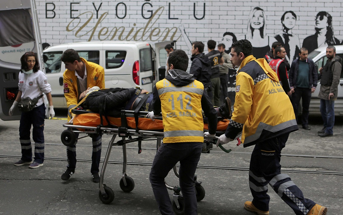 ATTENTION EDITORS - VISUAL COVERAGE OF SCENES OF INJURY OR DEATH  A man is helped by emergency services members following a suicide bombing in a major shopping and tourist district in central Istanbul March 19, 2016.    REUTERS/Kemal Aslan  TEMPLATE OUT.