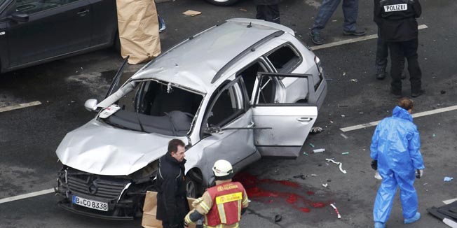 Police inspect the wreckage of a Volkswagen car after it exploded in Bismarckstrasse in Berlin, Germany March 15, 2016. German police said there was no indication of a 