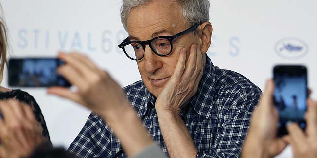 Journalists take pictures with their mobile phones as director Woody Allen attends a news conference during the 68th Cannes Film Festival in Cannes, southern France, in this May 15, 2015 file photo. Woody Allen's 