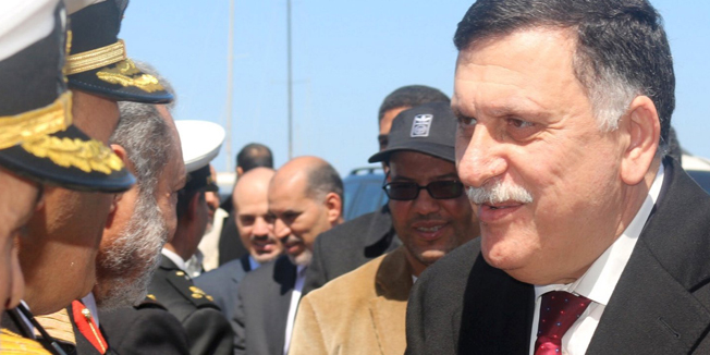 Libyan Prime Minister-designate Fayez Seraj (R) is greeted upon arrival in Tripoli, Libya March 30, 2016. REUTERS/Hani Amara