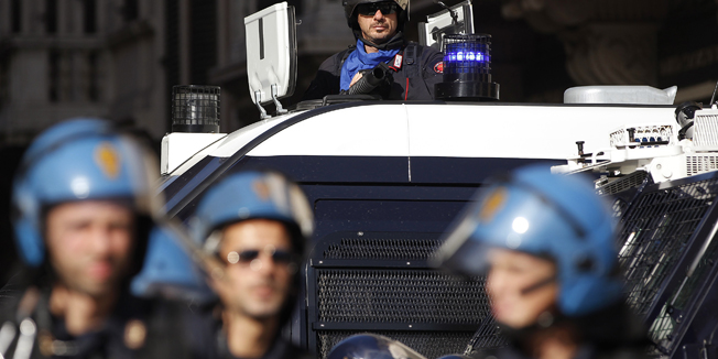Riot police stand guard during a demonstration against austerity measures in downtown Rome November 14, 2012. Millions went on strike across Europe on Wednesday to protest spending cuts they say have made the economic crisis worse. REUTERS/Tony Gentile (ITALY - Tags: POLITICS CIVIL UNREST BUSINESS) - RTR3AE5Y