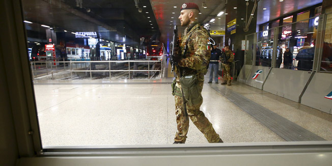 Soldiers patrol at the main railway station in Rome, Italy, January 25, 2016. Italy's main railway station reopened on Monday after police briefly evacuated the huge terminus following reports that an armed man was in the building, the state railways said.  REUTERS/Tony Gentile