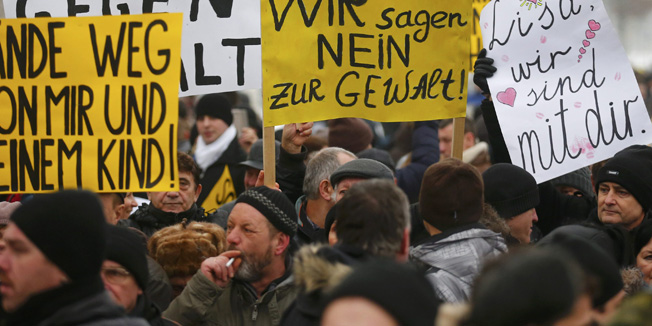 Activists and supporters of the 'International Convention of German Russians' protest against sexual harassment by migrants in front of the Chancellery in Berlin, Germany, January 23, 2016. The placards read 'Hands off from me and my child!', 'We say NO to violence' and 'Lisa, we are with you.'   REUTERS/Hannibal Hanschke 