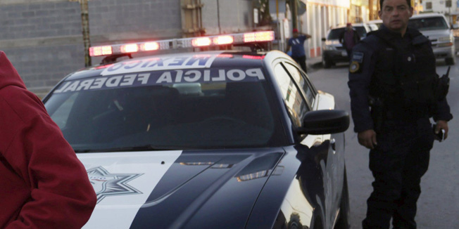 Cuban migrants are guarded by Federal Police after traveling en route from Costa Rica to El Salvador, Guatemala and Mexico, before continuing their journey to U.S., on the border between the U.S. and Mexico in Reynosa, in Tamaulipas state, Mexico, January 17, 2016. Mexico on January 13, 2016 said it plans to grant 20-day transit visas to a group of 180 Cubans who were chosen from thousands stranded in Costa Rica to continue on their long journey toward the United States. The Cubans will have to leave Mexican territory after the permits expire, the National Migration Institute said, adding the visas were given for humanitarian reasons. REUTERS/Daniel Becerril