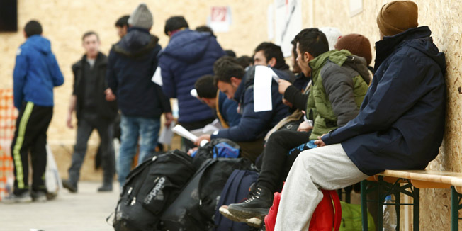 Migrants wait after they arrived in the first registration camp of Erding near Munich, Germany, January 27, 2016.  REUTERS/Michaela Rehle