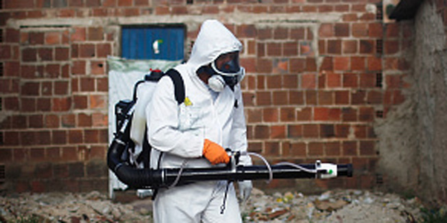 RECIFE, BRAZIL - FEBRUARY 04: A city worker fumigates in an effort to eradicate the mosquito which transmits the Zika virus on February 4, 2016 in Recife, Pernambuco state, Brazil. Officials say as many as 100,000 people may have already been exposed to the Zika virus in Recife, which is being called the epicenter of the crisis, although most never develop symptoms. Tourists are arriving in the city for its famed Carnival celebrations which begin tomorrow. (Photo by Mario Tama/Getty Images)