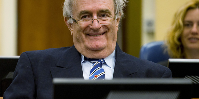 Former Bosnian Serb leader Radovan Karadzic sits in the courtroom on the first day of his defense against war crime charges at the International Criminal Tribunal for the Former Yugoslavia in The Hague October 16, 2012. The Yugoslavia  war crimes tribunal begins trying its last suspect on Tuesday. Karadzic is one of a trio of architects of the Balkan wars brought to trial in The Hague for wars among the successor countries and the peoples of multi-ethnic Yugoslavia between 1991 and 1999, in which well over 100,000 people were killed and millions were displaced. REUTERS/Robin van Lonkhuijsen  (NETHERLANDS - Tags: POLITICS CRIME LAW CONFLICT TPX IMAGES OF THE DAY) - RTR396U0