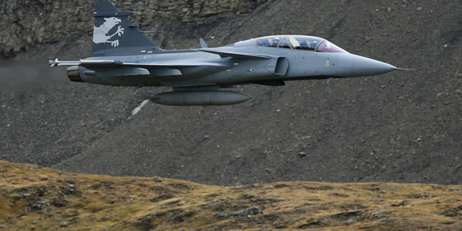 A Swedish Saab Gripen fighter jet performs during a flight demonstration of the Swiss Air Force over the Axalp in the Bernese Oberland, October 11, 2012. The Swiss Army plans to replace their older Tiger fighter jets with the Saab Gripen planes. REUTERS/Pascal Lauener (SWITZERLAND - Tags: POLITICS MILITARY TRANSPORT) - RTR390WU