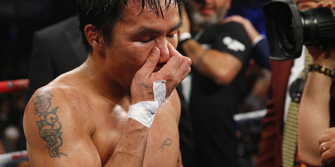 Manny Pacquiao of the Philippines reacts after losing to Floyd Mayweather, Jr. of the U.S. following their welterweight WBO, WBC and WBA (Super) title fight in Las Vegas, Nevada, May 2, 2015.    REUTERS/Steve Marcus - RTX1BATX