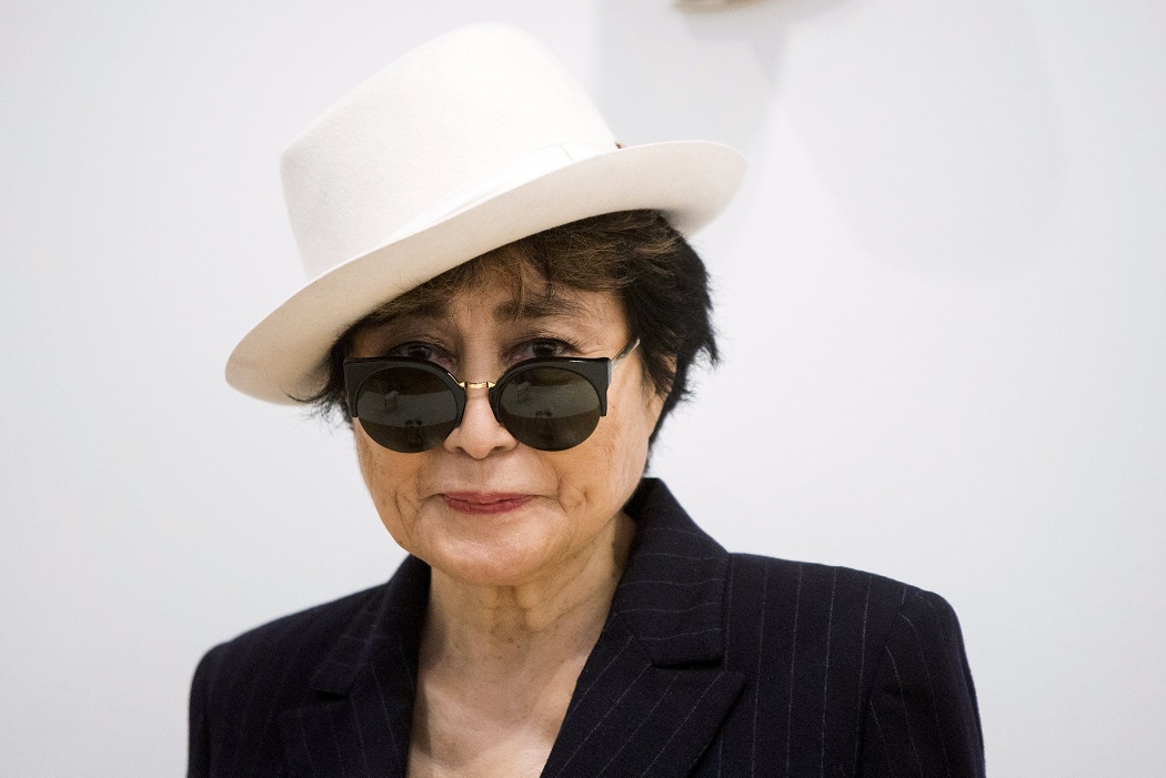 Artist Yoko Ono stands in the exhibit 