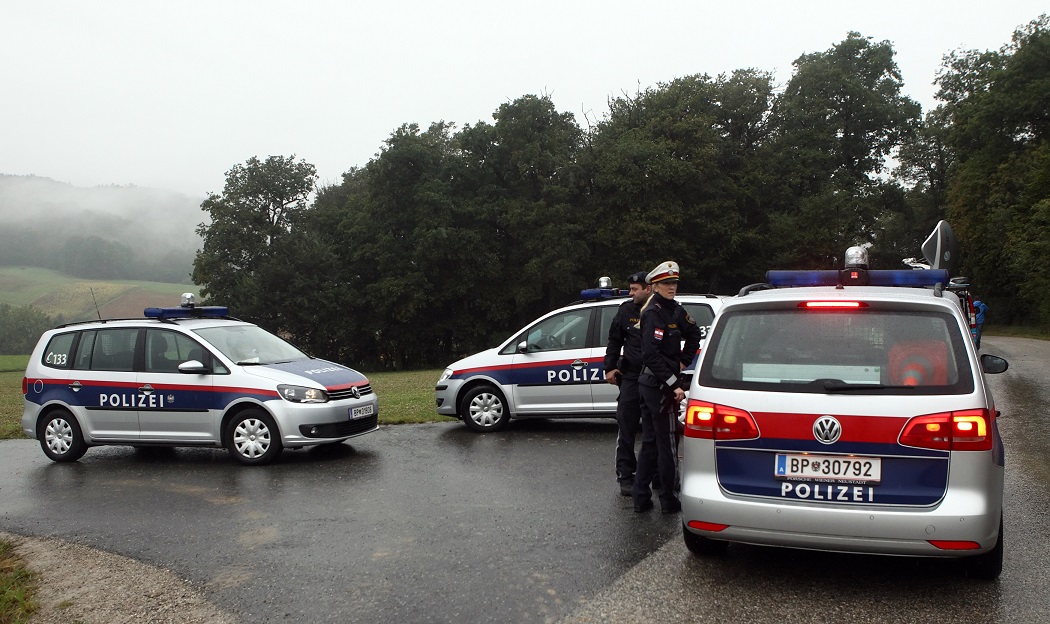 Police block the road to the premises belonging to a suspected poacher who had shot dead three policemen and a paramedic in Grosspriel near Melk, about 80 km (50 miles) west of Vienna September 18, 2013. The man, whom police identified as Alois H., fired repeatedly at police surrounding the farmhouse. After an hours-long standoff, police entered the house and found a charred body in a basement hideaway, Austrian media quoted a police spokesman as saying. REUTERS/Heinz-Peter Bader (AUSTRIA - Tags: CRIME LAW) - RTX13PH5