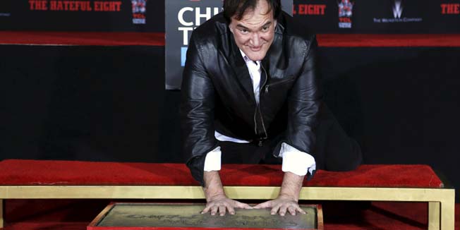 Director Quentin Tarantino places his handprints in cement in the forecourt of the TCL Chinese theatre in Hollywood, California January 5, 2016. REUTERS/Mario Anzuoni      TPX IMAGES OF THE DAY     