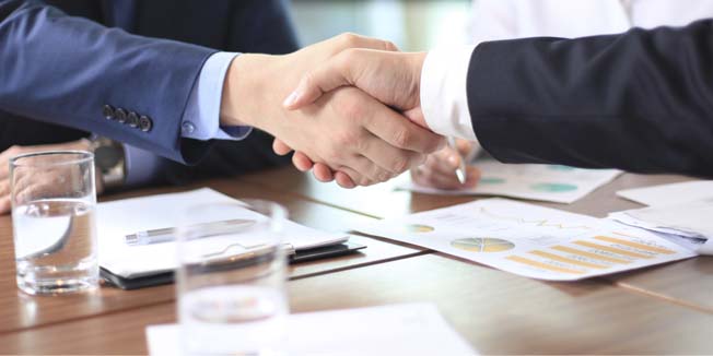 Business people shaking hands, finishing up a meeting