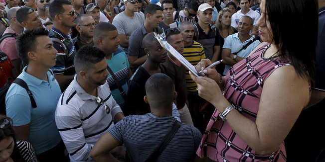 Costa Rica's Immigration Administration Director, Kathya Rodriguez calls the roll of Cubans leaving for their journey to the Guatemala-Mexico border in La Cruz, Costa Rica, January 12, 2016. A group of around 180 Cuban migrants will be able to leave on a flight to El Salvador Tuesday evening and will then have ground transportation to the Guatemala-Mexico border, Costa Rica's Foreign Minister Manuel Gonzalez said. REUTERS/Juan Carlos Ulate