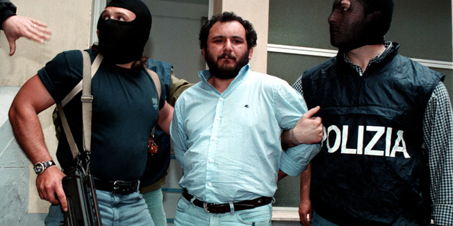 Anti-Mafia police wearing masks to hide their identity, escort top Mafia fugitive Giovani Brusca May 21 as he leaves Palermo's police headquarters to be taken to a maximum security prison. Brusca, accused of mastermining the highway bombing that killed anti-mob judge Giovanni Falcone along with his wife and three bodyguards on May 23, 1992, and is also beleived to have succeeded Salvatore 