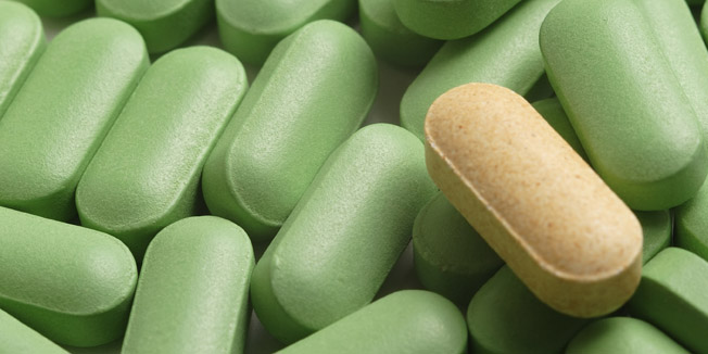 A yellow caplet amongst green