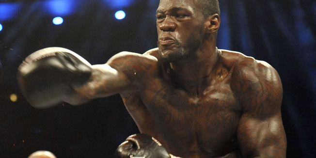 Oct 26, 2013; Atlantic City, NJ, USA; Deontay Wilder (bronze trunks) and Nicolai Firtha (black trunks) box during their WBA Continental Americas Heavyweight title bout at Boardwalk Hall. Wilder won via fourth round TKO Mandatory Credit: Joe Camporeale-USA TODAY Sports - RTX14PMQ