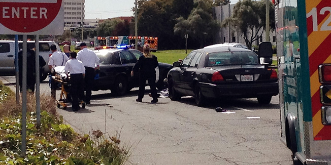 This image taken with a cell phone shows the early moments of the scene outside of Oikos University in Oakland, Calif., Monday, April 2, 2012. Police surrounded the Christian university in search of a gunman who reportedly opened fire Monday morning, killing at least five people, authorities said. (AP Photo/San Francisco Chronicle, Demian Bulwa)   MANDATORY CREDIT FOR PHOTOGRAPHER AND SF CHRONICLE; NO SALES; MAGS OUT; TV OUT