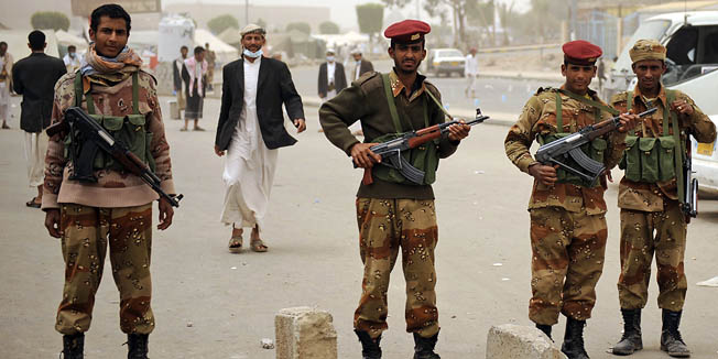 Yemeni army soldiers in charge of protecting anti-government protestors stand guard during a demonstration demanding the resignation of Yemeni President Ali Abdullah Saleh, in Sanaa,Yemen, Monday, March 28, 2011. Yemen's president, clinging to power despite weeks of protests, scrapped an offer to step down by year's end on Sunday, as Islamic militants taking advantage of the deteriorating security took control of another southern town. (AP Photo/Hani Mohammed)