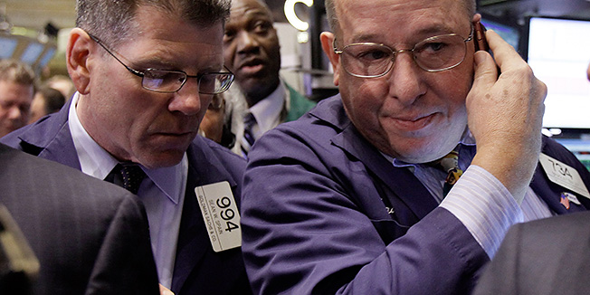 Traders work on the floor of the New York Stock Exchange Thursday, April 19, 2012. U.S. stocks are opening flat as investors weigh stronger corporate earnings against a disappointing jobs report. (AP Photo/Richard Drew)