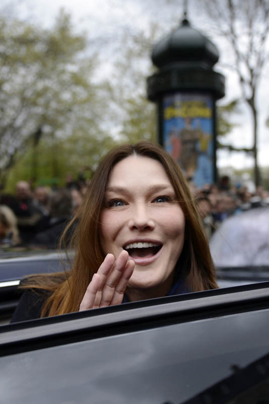 Carla Bruni-Sarkozy, the wife of French President and UMP party candidate Nicolas Sarkozy, gestures as she enters a car after they cast their ballots at a polling station in the first round of French presidential elections in Paris, France, Sunday, April 22, 2012. (AP Photo/Eric Feferberg, Pool)