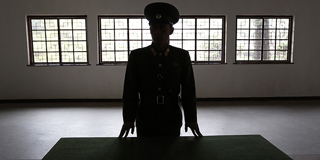 A North Korean military officer talks the history at a museum hall at Demilitarized Zone that separates the two Koreas in Panmunjom, North Korea Monday, April 23, 2012. North Korea promised Monday to reduce South Korea's conservative government 