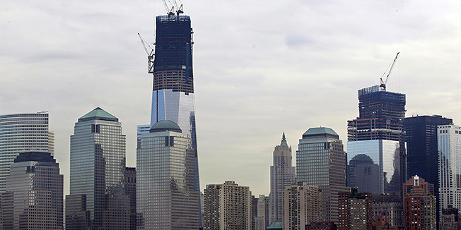 In this view from a ferry boat near Jersey City, N.J. , ongoing construction can be seen of One World Trade Center, left, and Four World Trade Center in lower Manhattan in the early Thursday, April 19, 2012. (AP Photo/Mel Evans)  