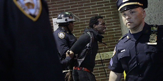 A demonstrator is arrested after the police department closed the Vietnam memorial at 10pm,  Tuesday, May 1, 2012 in New York. Hundreds of activists with a variety of causes spread out over New York City Tuesday on International Workers Day, or May Day, with Occupy Wall Street members leading a charge against financial institutions. (AP Photo/Mary Altaffer)