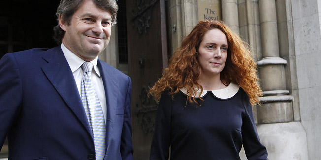 FILE This Friday, May 11, 2012 file photo shows Rebekah Brooks, former chief executive of News International and her husband Charlie Brooks leaving the High Court in London after giving evidence to the Leveson Inquiry. Brooks said Tuesday May 15, 2012 she and her husband will face charges over Britain's tabloid phone hacking scandal. Brooks, 43, said Tuesday in a statement that she will be prosecuted over allegations of obstruction of justice. (AP Photo/Sang Tan)