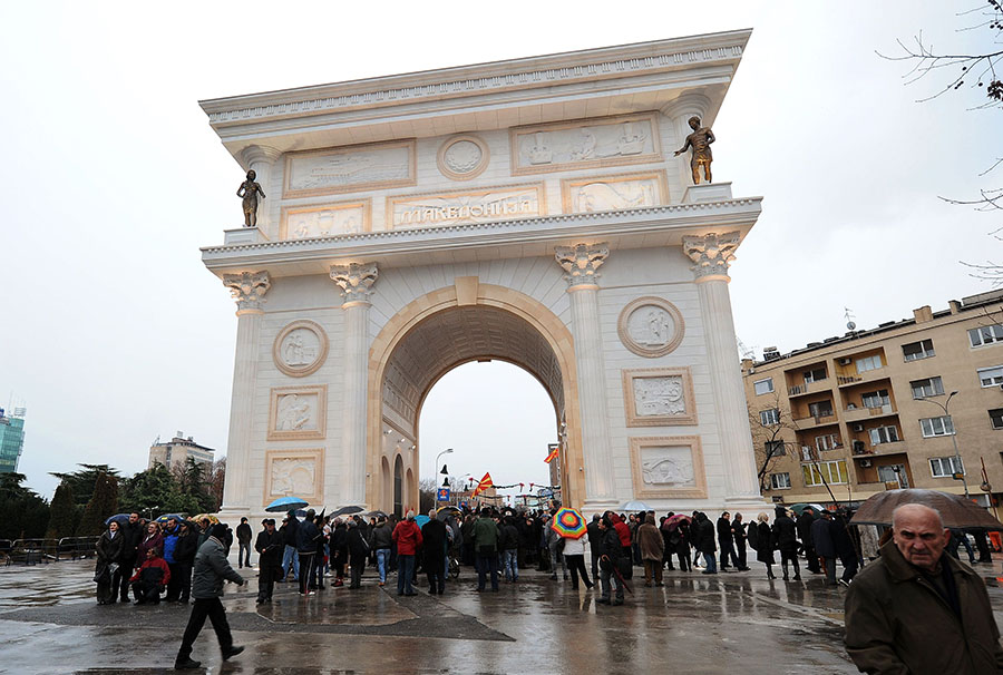 People walk in front of a new Triumphal Arch in Skopje on January 6, 2012.Today was the opening of the Triumphal Arch named Porta Macedonia, which shows motives of the Macedonian struggle, culture and tradition. AFP  PHOTO/ROBERT ATANASOVSKI