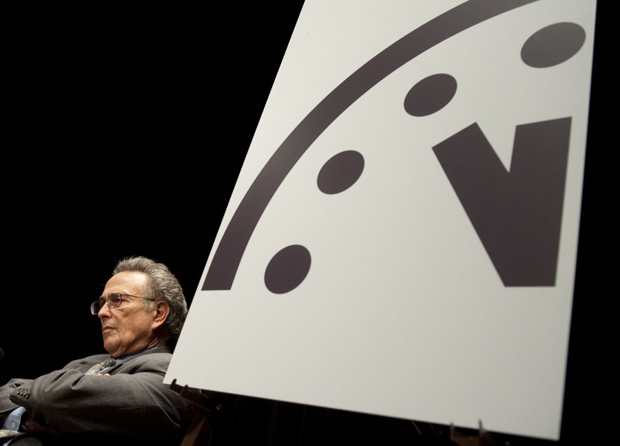 Robert Socolow, a professor at Princeton University, sits alongside the Doomsday Clock during an announcement by the Bulletin of Atomic Scientists (BAS) announcing that it has moved the hands to five minutes to midnight, up one minute from two years ago, at the American Association for the Advancement in Washington, DC, on January 10, 2012. The closer the time on the Doomsday Clock is to midnight, the closer the world is to global disaster according to the organization. Citing what they called 