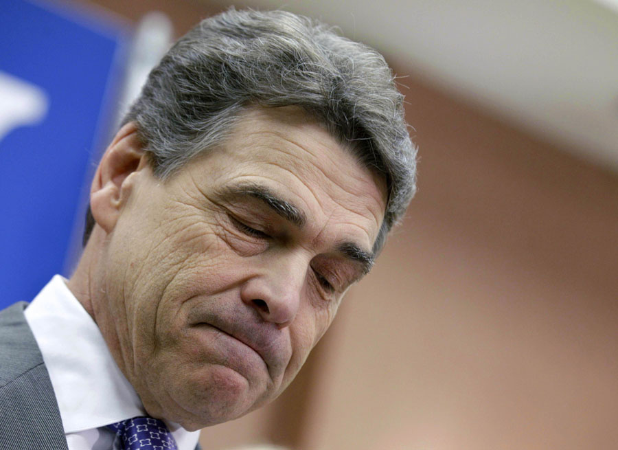 Republican presidential candidate, Texas Gov. Rick Perry pauses while announcing he is suspending his campaign and endorsing Newt Gingrich, Thursday, Jan. 19, 2012, in North Charleston, S.C. (AP Photo/David Goldman)