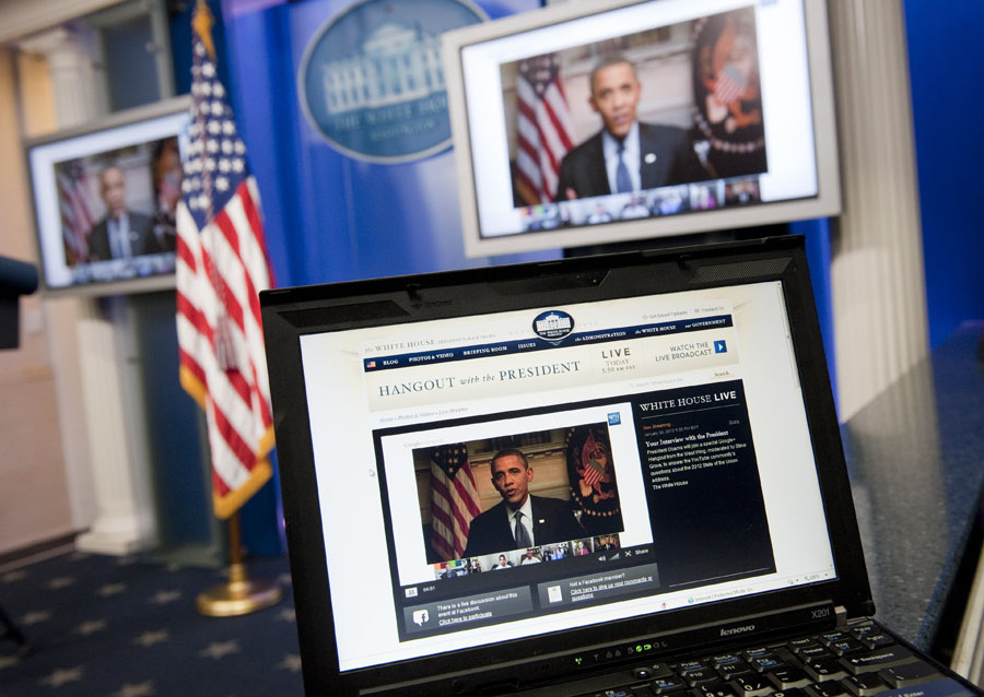 US President Barack Obama participates in an interview with YouTube and Google from the Roosevelt Room of the White House in Washington, DC, January 30, 2012, as seen on a laptop in the Brady Press Briefing Room. The interview, held through a Google+ Hangout, marks the first completely virtual interview of a US President from the White House.  AFP PHOTO / Saul LOEB