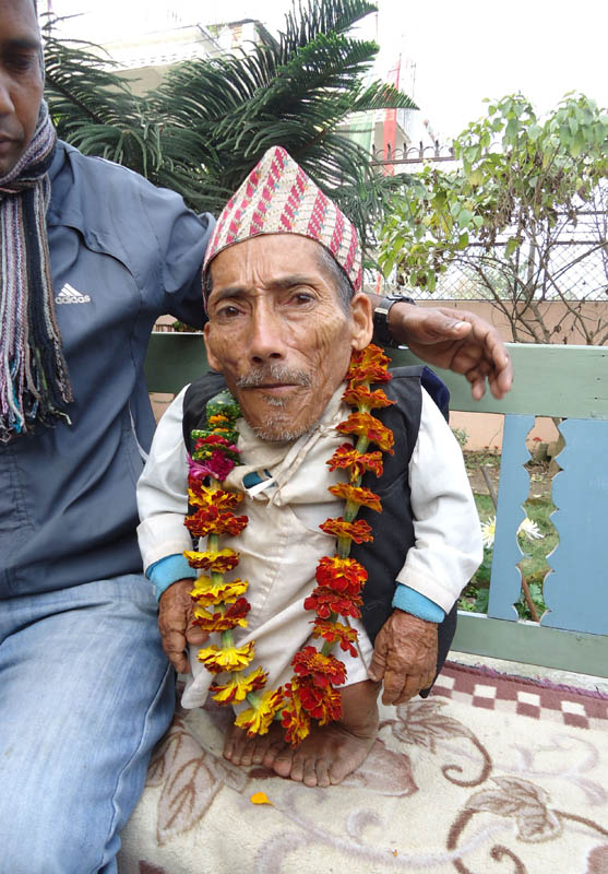 The pictures taken on January 30, 2012 show Chandra Bahadur Dangi, a 72-year-old Nepali who claims to be the world's shortest man at 56 centimetres (22 inches) tall, at a media conference in Jhapa district, southeastern Nepal. Guinness World Records experts said they are to travel to a remote valley in southwestern Nepal to measure a 72-year-old claiming to be the world's shortest man. AFP PHOTO/Subrat Neupane