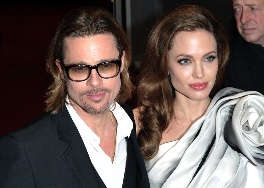 US actress and director Angelina Jolie (R) and her partner US actor Brad Pitt pose on the red carpet during the premiere of her film 