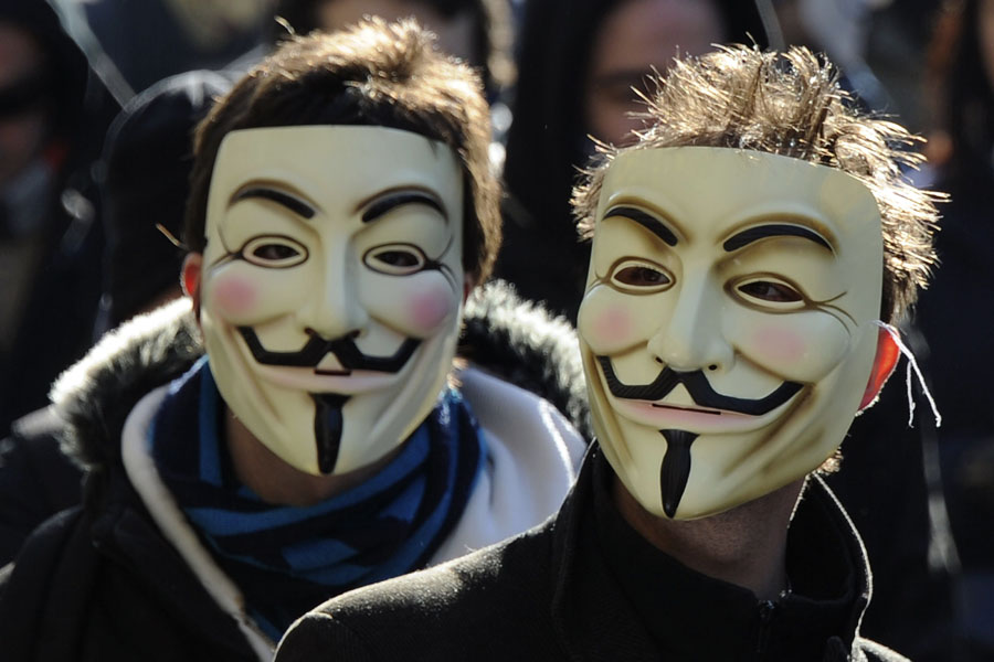 Demonstrators wearing Anonymous Guy Fawkes masks attend a protest against the Anti-Counterfeiting Trade Agreement (ACTA) on February 11, 2012 in Paris. Protesters have adopted as their own the now-iconic wryly smiling, mustachioed Guy Fawkes cartoon character masks of the global hacker group Anonymous. ACTA's aim is to beef up international standards for intellectual property protection, for example by doing more to fight counterfeit medicine and other goods. But it is ACTA's potential role in cyberspace that has caused outcry online and on the streets. AFP PHOTO JOHANNA LEGUERRE