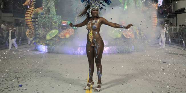 A reveller of Rosas de Ouro samba school dances during the opening night of parades at the Sambadrome, as part of Carnival celebrations in Sao Paulo on February 18, 2012.      AFP PHOTO / BRAZIL PHOTO PRESS / VANESSA CARVALHO