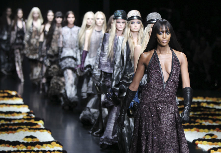 Britain top model Naomi Campbell, right, wears with others models creations part of the Roberto Cavalli women's Fall-Winter 2012-13 fashion collection, during the fashion week in Milan, Italy, Monday, Feb. 27, 2012. (AP Photo/Antonio Calanni)