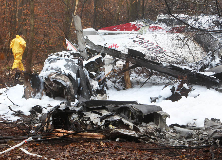 The remains of an aircraft lie in a forest in Egelsbach, near Frankfurt, Germany, Friday, March 2, 2012. Police said the plane, with five people on board, crashed and burst into flames late Thursday as it tried to land at Egelsbach airstrip. Three bodies have been recovered so far. (AP Photo/Michael Probst)