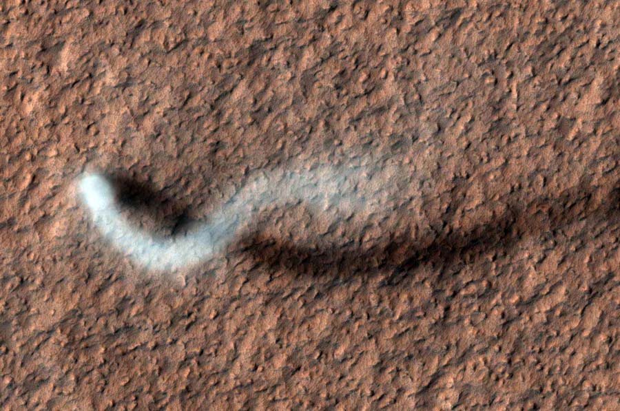 This handout image released March 7, 2012 by NASA shows  towering dust devil casting a serpentine shadow over the Martian surface in this image acquired by the High Resolution Imaging Science Experiment (HiRISE) camera on NASA's Mars Reconnaissance Orbiter. The scene is a late-spring afternoon in the Amazonis Planitia region of northern Mars. The view covers an area about four-tenths of a mile (644 meters) across. North is toward the top. The length of the dusty whirlwind's shadow indicates that the dust plume reaches more than half a mile (800 meters) in height. The plume is about 30 yards (27 meters) in diameter.  = RESTRICTED TO EDITORIAL USE - MANDATORY CREDIT 