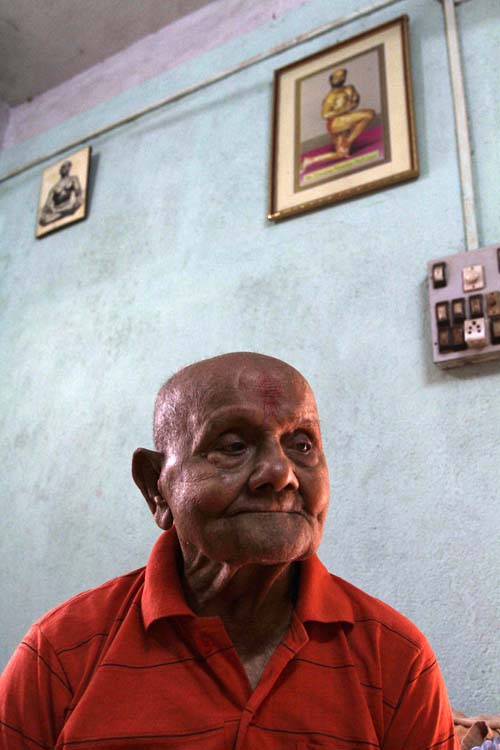 Indian body builder Manohar Aich looks on at his residence in Kolkata, India, Sunday, March 18, 2012. Aich, who is only 4 foot 11 inches (150 centimeters) tall, won the Mr. Universe title in London way back in 1952. Happiness and a life without tensions are the key to his longevity, said Aich, who turned 100 on March 17. (AP Photo/Bikas Das)