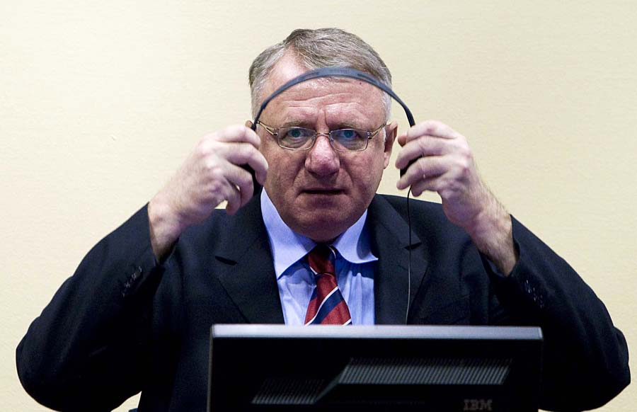 FILE - In this March 6, 2009 file photo Serbian ultranationalist leader Vojislav Seselj seen in court at the International Criminal Tribunal for the former Yugoslavia (ICTY) in The Hague, Netherlands. Seselj, 58, is to start making his closing arguments on Wednesday, March 14, 2012. Seselj has been charged with crimes against Muslims and Croats, allegedly committed by the volunteers recruited by his party during 1991-1995 war that followed the breakup of the former Yugoslavia. (AP Photo/Valerie Kuypers, Pool, File)