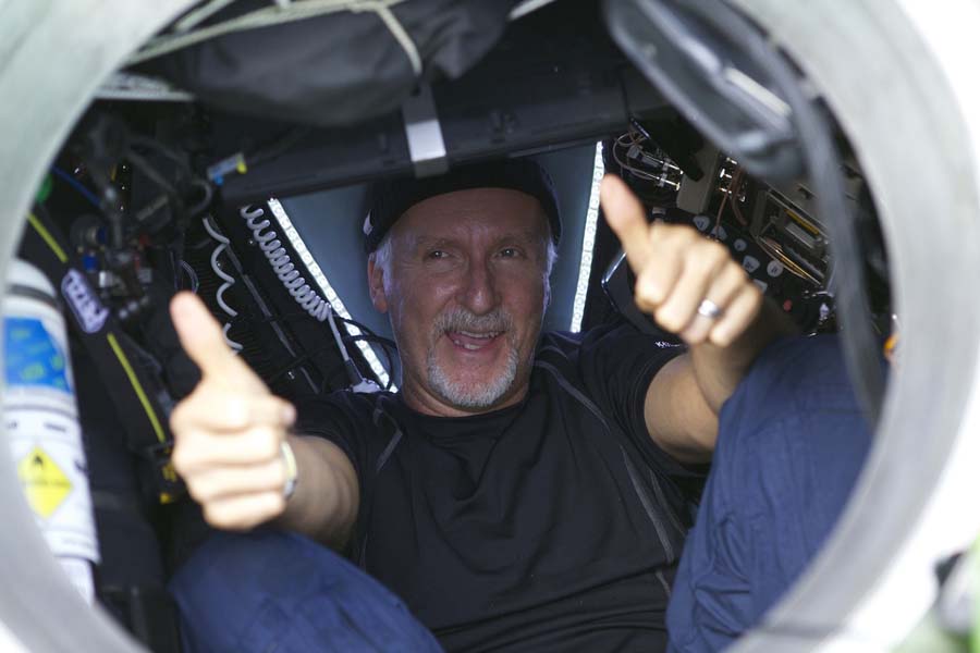 Filmmaker and National Geographic Explorer-in-Residence James Cameron gives two thumbs-up as he emerges from the DEEPSEA CHALLENGER  submersible after his successful solo dive March 26, 2012 to the Mariana Trench, the deepest part of the ocean. Cameron plunged about seven miles (11 kilometers) to the bottom of the Marina Trench in the western Pacific, where temperatures are barely above freezing and the pressure is a crushing thousand times that at sea level. The dive was part of DEEPSEA CHALLENGE, a joint scientific expedition by Cameron, the National Geographic Society and Rolex to conduct deep-ocean research.    One-time use for coverage or promotion of DEEPSEA CHALLENGE dated 2012 and exclusively in conjunction thereof. Copying, distribution, archiving, sublicensing, sale, or resale of the image is prohibited. AFP PHOTO/HANDOUT/ Mark Thiessen/National Geographic  == One-time use for coverage or promotion of DEEPSEA CHALLENGE dated 2012 and exclusively in conjunction thereof. Copying, distribution, archiving, sublicensing, sale, or resale of the image is prohibited ==   DEFAULT: Failure to comply with the prohibitions and requirements set forth above will obligate the individual or entity receiving this image to pay a fee determined by National Geographic.
