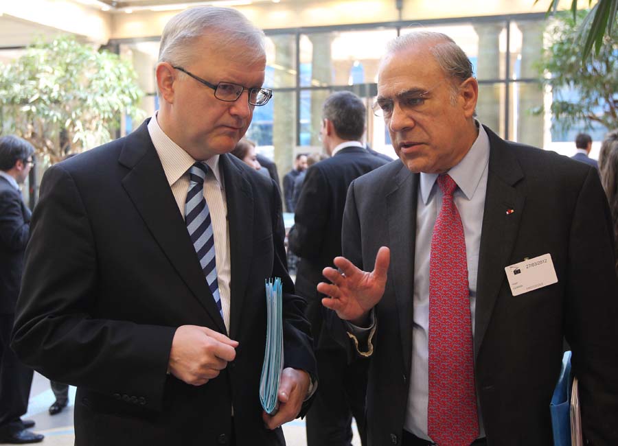 Angel Gurria, the head of the Paris-based international development body OECD, right, talks with European Commissioner for Economic and Monetary Affairs Olli Rehn prior to a media conference, in Brussels, Tuesday, March 27, 2012. The 17 countries that use the euro should boost their crisis firewalls to at least euro 1 trillion (U.S. dollars 1.3 trillion) to help the struggling currency union return to growth, the head of the Organization for Economic Cooperation and Development said Tuesday. (AP Photo/Yves Logghe)