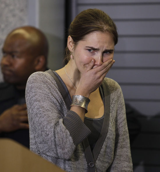 Amanda Knox gestures at a news conference in Seattle Tuesday, Oct. 4, 2011, after returning home from Italy. Knox was freed Monday after an Italian appeals court threw out her murder conviction for the death of her British roommate, Meredith Kercher. (AP Photo/Ted S. Warren)