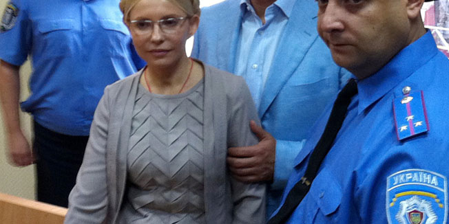 (FILES) A file photo taken on August 11, 2011 shows Former Ukrainian Prime Minister Yulia Tymoshenko (C) inside a courtroom in Kiev. The judge in her trial, Rodion Kireyev, said in the verdict on October 11 that Tymoshenko clearly had exceeded her authority in signing a gas deal with Russia in 2009 and used her powers to 